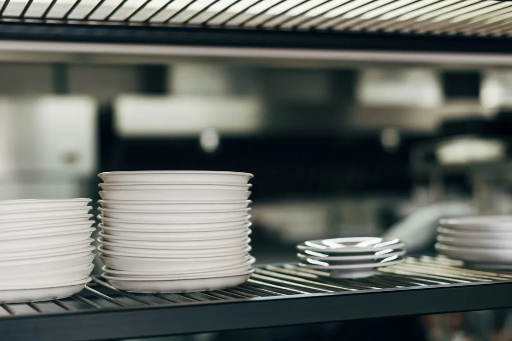 Professional Catering Equipment And Logistics Services in Melbourne, such as these white dinner plates stacked ready for meal service