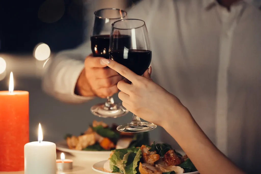Soft light, candles and red wine at an Intimate Engagement Dinner Catering by White Knight Catering Services