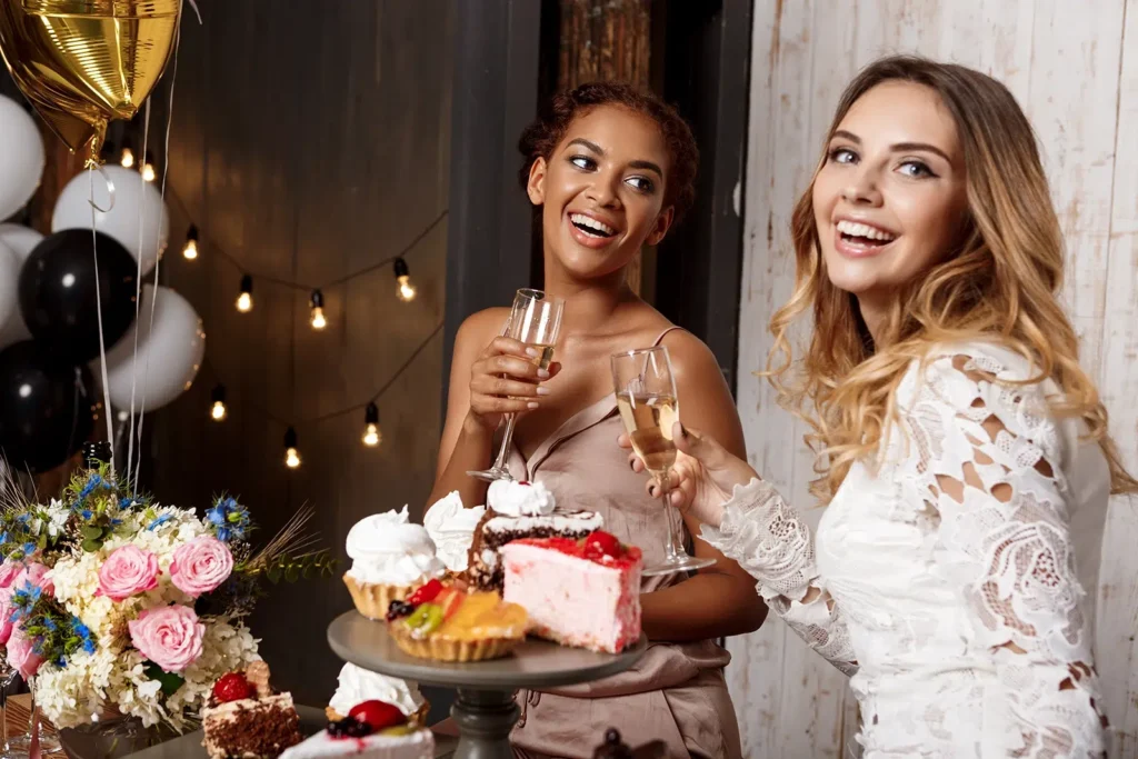 Two beautiful young ladies smiling and sipping Champagne at Pre-Wedding Celebration Catering in Melbourne