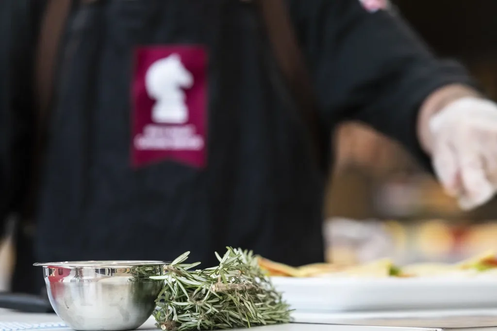 Executive Chef Ashley Hann garnishing a dish with herbs for Pre-Wedding-Celebration-Catering