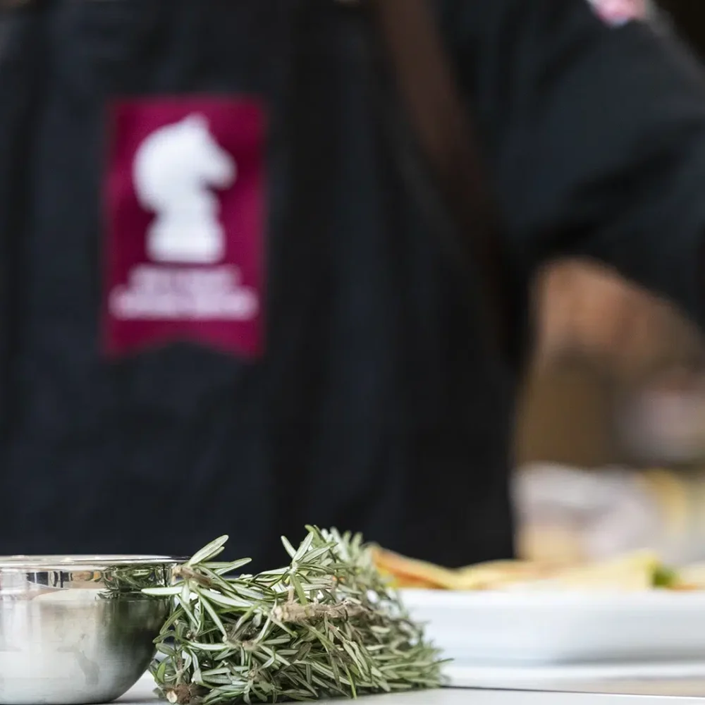 Executive Chef Ashley Hann garnishing a dish with herbs for Pre-Wedding-Celebration-Catering