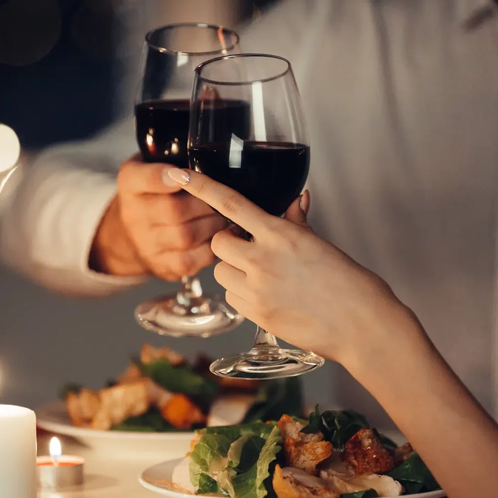 Soft light, candles and red wine at an Intimate Engagement Dinner Catering by White Knight Catering Services