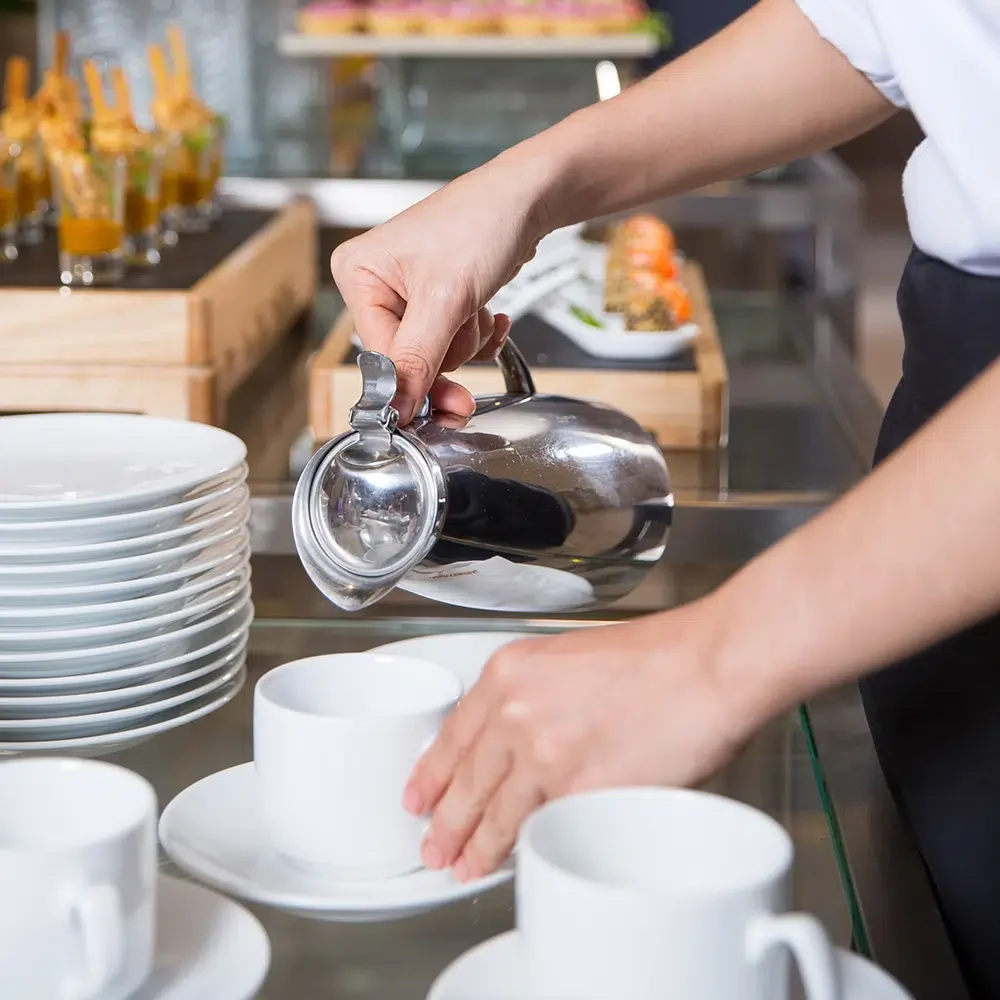 Waitress-Serving-Coffee-For-Corporate-Guesses-At-A-Buffet-Lunch-SQ.webp